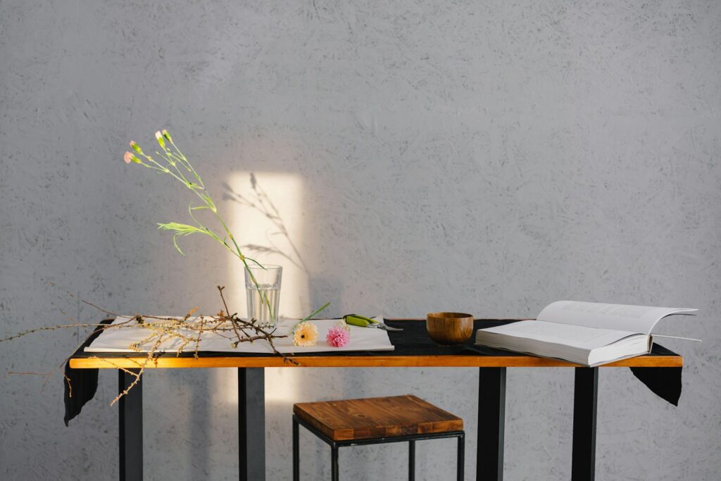 a table with fake flower and books on it