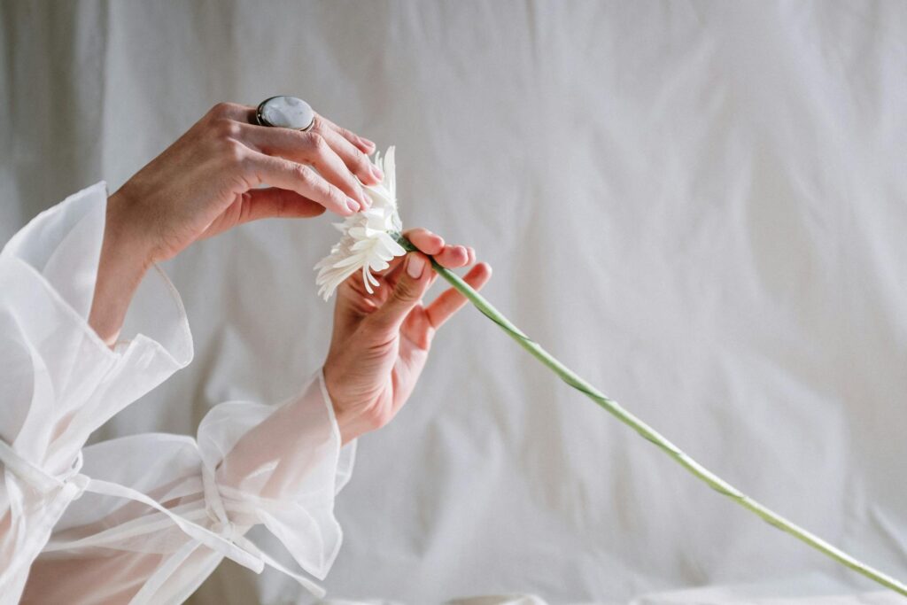 a girl toucing white fake flowers