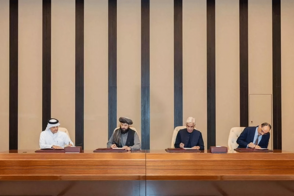 Afghan Defense Minister, Mullah Mohammad Yaqoob Mujahid and Pakistan's Defense Minister, Khawaja Muhammad Asif shake hands, following the signing of a ceasefire agreement, during a negotiations meeting mediated by Qatar and Turkey, in Doha, Qatar, Sunday.