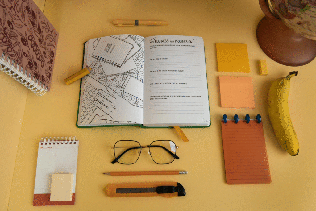 an image of journal equipment like dairy, pen etc